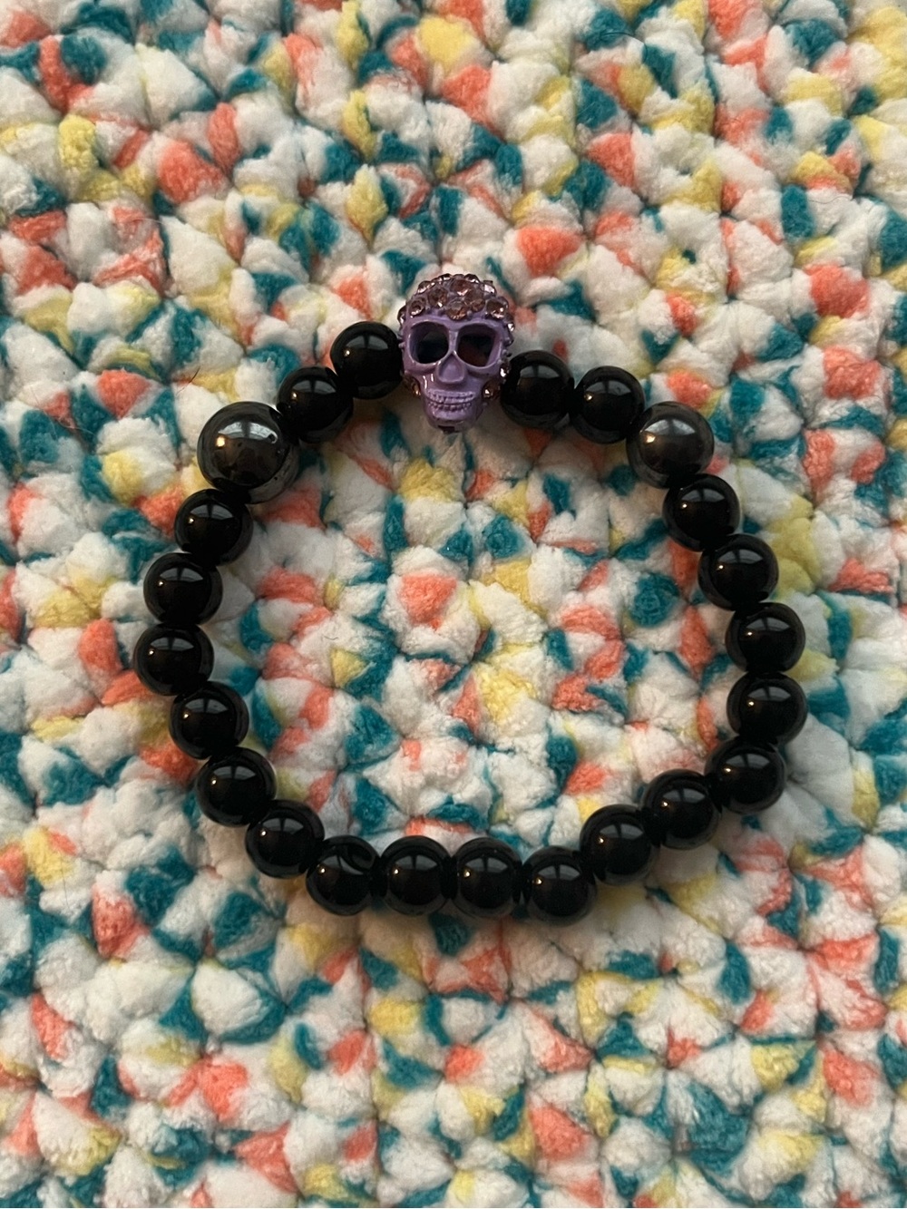 Black beaded skull purple rhinestone stretch bracelet